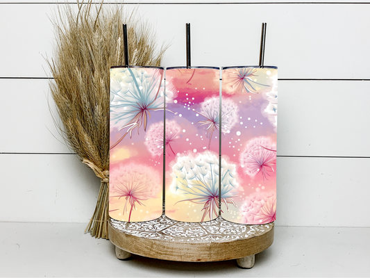 Wispy dandelions blowing in the wind on a pastel background. 600mL double walled stainless steel skinny tumbler leak proof with steel straw.